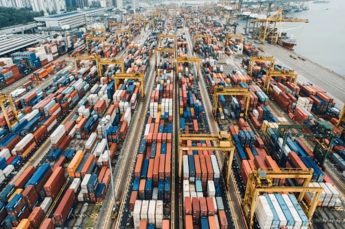 Aerial view of shipping containers and cranes at a container port